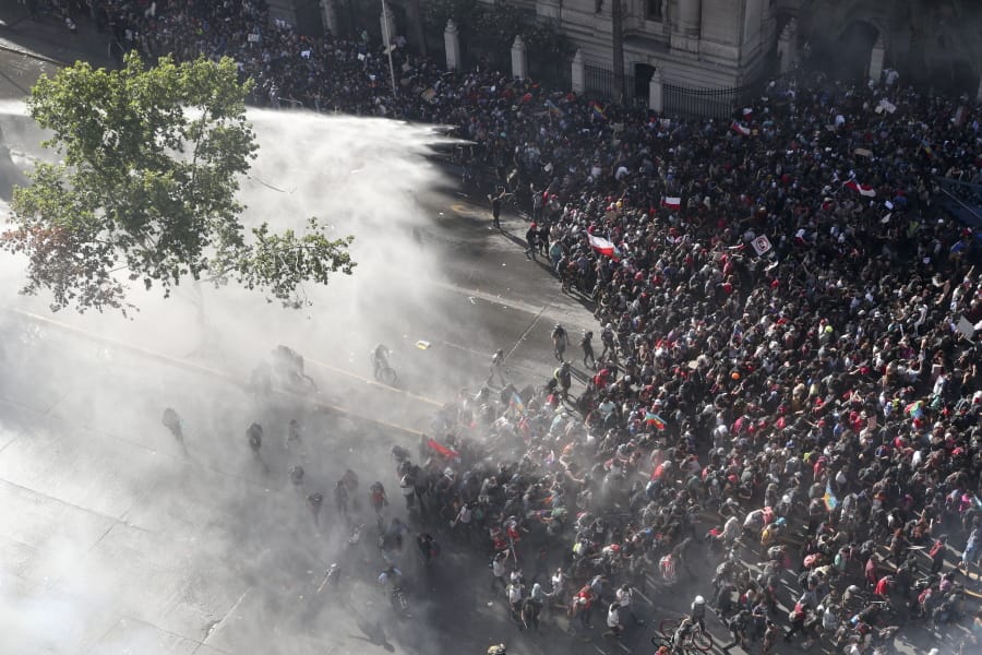 Police sprays water on anti-government demonstrators in Santiago, Chile, Monday, Oct. 28, 2019.