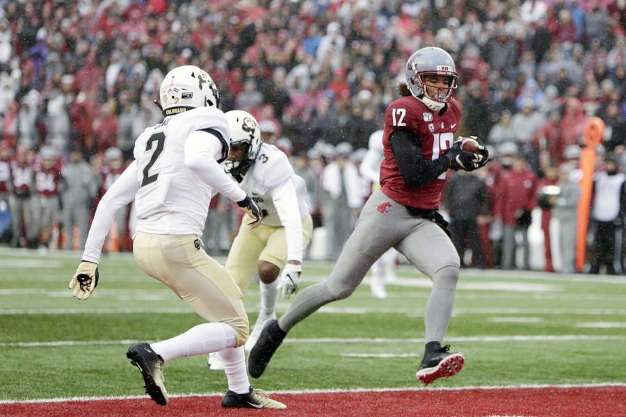 Washington State wide receiver Dezmon Patmon (12) runs for a touchdown in front of Colorado safety Mikial Onu (2) during the first half of an NCAA college football game in Pullman, Wash., Saturday, Oct. 19, 2019.