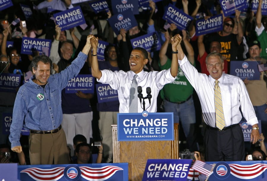 FILE - In this Oct. 9, 2008, file photo, Democratic presidential candidate Sen. Barack Obama, D-Ill., middle, is introduced by Sen. Sherrod Brown, D-Ohio., left, and Ohio Gov. Ted Strickland, right, during a rally at Shawnee State University, in Portsmouth, Ohio. As Democrats bring their primary debate to Ohio Tuesday, the question is whether the Republican foothold in Appalachia and places like industrial Youngstown is irreversible, whether Ohio is a political battleground no more.
