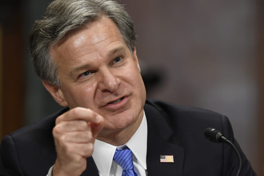 FILE - In this July 23, 2019 file photo, FBI Director Christopher Wray testifies before the Senate Judiciary Committee on Capitol Hill in Washington.  Wray says there is &quot;a way forward&quot; to allow police officers to wear body cameras on federal task forces while speaking at the International Association of Chiefs of Police conference in Chicago, Saturday, Oct. 26.