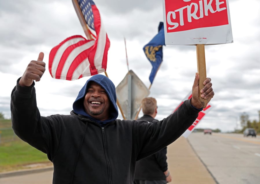 Bill Jackson, of St. Louis, gives a thumbs up to drivers that wave or honk as United Auto Workers outside the GM Wentzville Assembly Center in Wentzville, Mo.,  Wednesday, Oct. 16, 2019. UAW workers have been on strike since Sept. 16, but have reached a tentative deal with GM today. Workers expressed cautious optimism, but will likely remain on the picket line until an official deal has been reached. (Cristina M. Fletes/St.