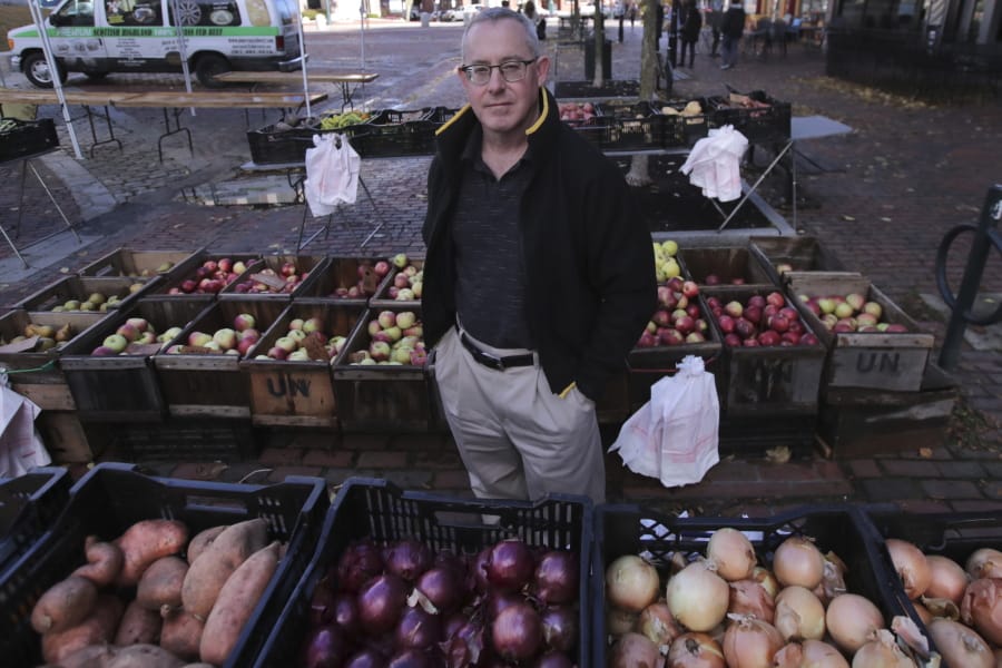 John Gold, self-employed graphics designer, poses at a farmer&#039;s market outside his office in Portland, Maine, Wednesday, Oct. 23, 2019. Gold has been covered by the Affordable Care Act since it started, plans on shopping for plans for 2020 again when the enrollment season starts Nov. 1. The 2020 sign-up season for the Affordable Care Act is getting underway with premiums down slightly in many states and more health plan choices for consumers.
