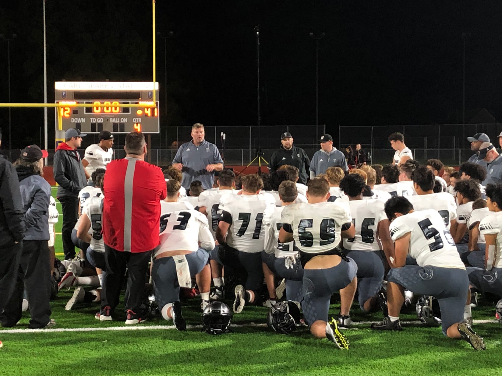 Union football coaches offer words of encouragement to player after a 42-41 loss to Puyallup on Saturday at Sparks Stadium in Puyallup (Micah Rice/The Columbian)
