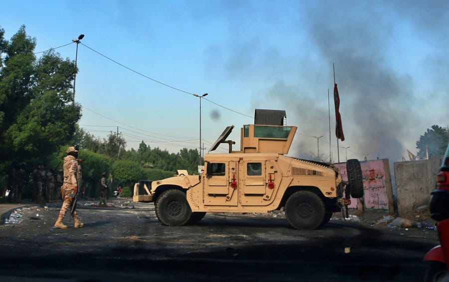 Iraqi Army troops deploy at a site of protests in Baghdad, Iraq, Sunday, Oct. 6, 2019. The spontaneous protests which started Tuesday in Baghdad and southern cities were sparked by endemic corruption and lack of jobs. Security forces responded with a harsh crackdown, with dozens killed.