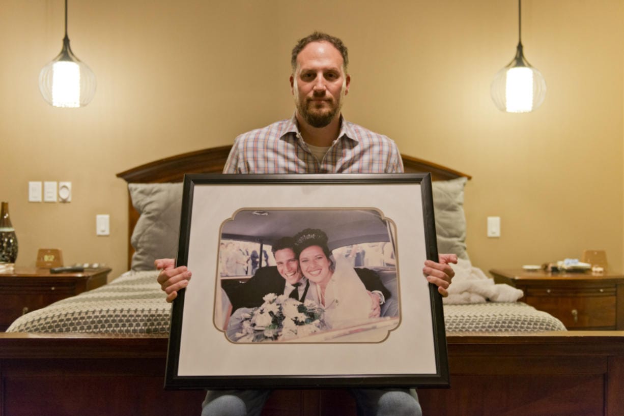 Andy Miller with a photo of his wedding day 20 years ago when he married Jaime Miller. PeaceHealth has started an endowment fund to benefit low income breast cancer patients in honor of Miller, a Vancouver mother of two who died of complications from triple-negative breast cancer at age 42 last year.