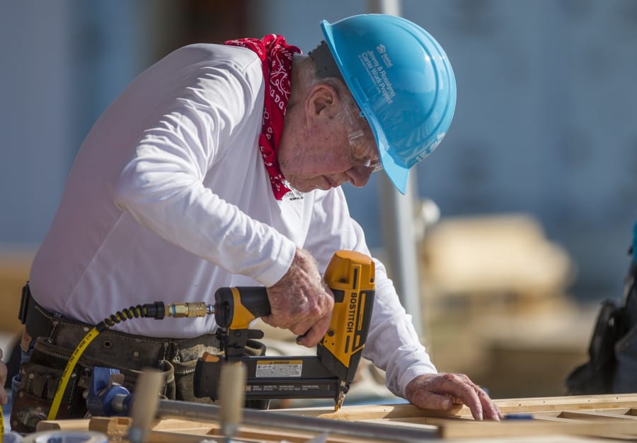 FILE- In this Aug. 27, 2018 file photo, former President Jimmy Carter works with other volunteers on site during the first day of the weeklong Jimmy &amp; Rosalynn Carter Work Project, their 35th work project with Habitat for Humanity, in Mishawaka, Ind. Carter turns 95 on Tuesday, Oct. 1, 2019.