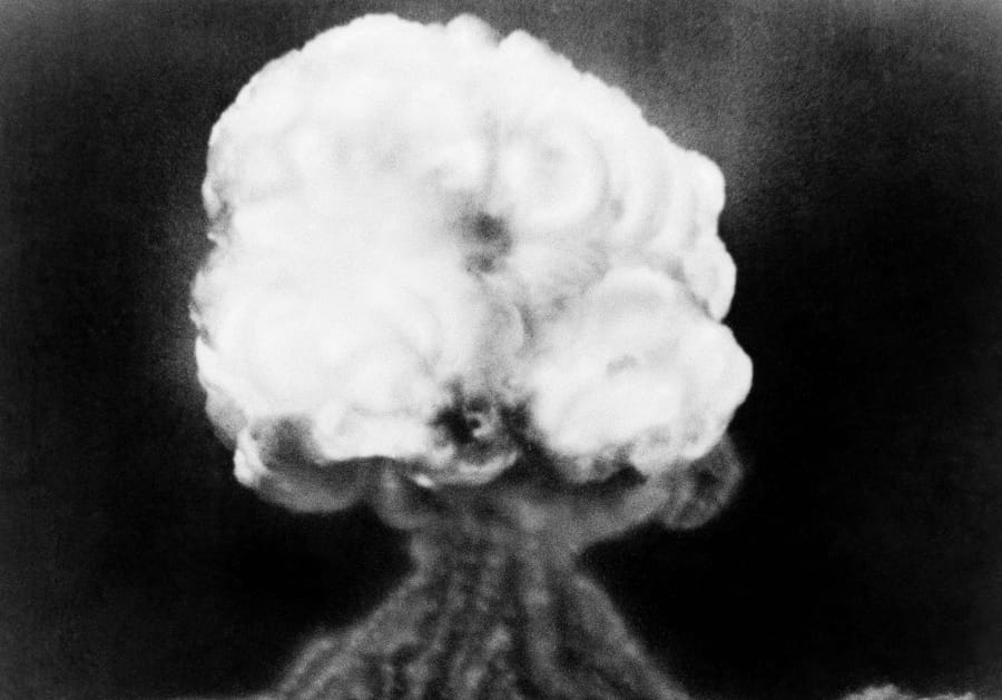 FILE - This July 16, 1945, file photo, shows the mushroom cloud of the first atomic explosion at Trinity Test Site near Alamagordo, N.M. A fight is raging in courts and Congress over where radioactive materials should be stored and how to safely get the dangerous remnants of decades of bomb-making and power generation to a permanent resting place.