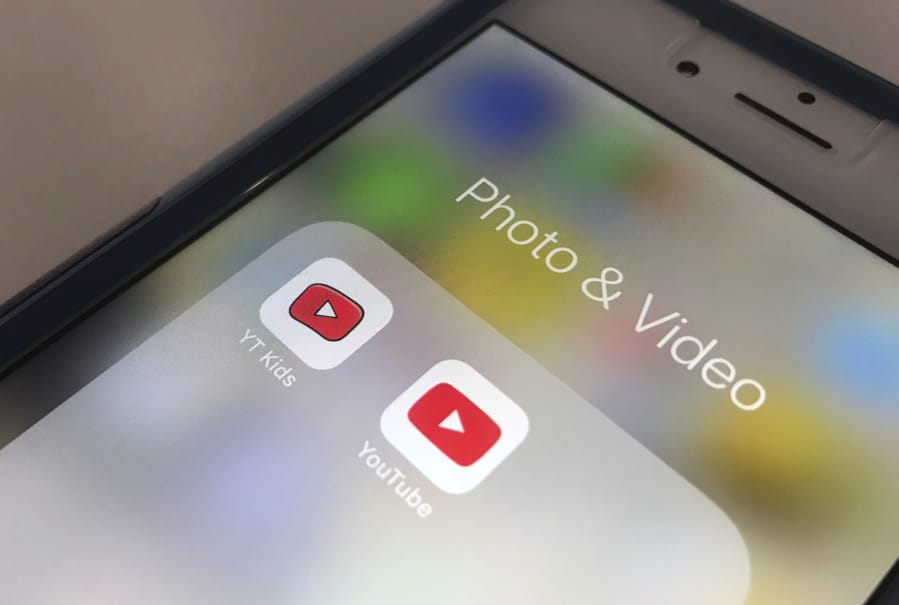 FILE - In this Wednesday, April 25, 2018, file photo, the YouTube app and YouTube Kids app are displayed on a smartphone in New York. A new survey confirms what a lot of parents already know: Teens and tweens are consuming a lot of online video, often on services such as YouTube.
