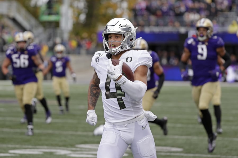 Oregon&#039;s Mycah Pittman leaves Washington defenders behind as he runs after a pass reception for a 36-yard touchdown in the second half of an NCAA college football game Saturday, Oct. 19, 2019, in Seattle. Oregon won 35-31.