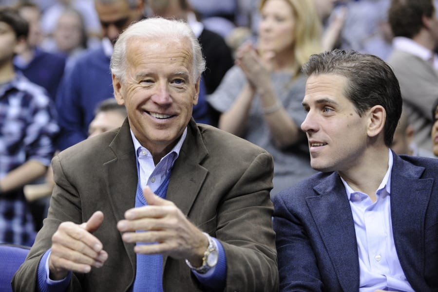 Vice President Joe Biden, left, with his son Hunter, right, at the Duke-Georgetown NCAA college basketball game Jan. 30, 2010, in Washington.
