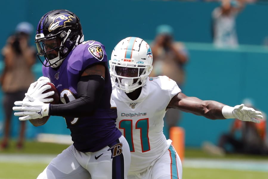 FILE - In this Sept. 8, 2019, file photo, Baltimore Ravens free safety Earl Thomas (29) intercepts a pass, as Miami Dolphins wide receiver DeVante Parker (11), attempts to tackle, during the first half at an NFL football game, in Miami Gardens, Fla. Over the course of nine NFL seasons with the Seattle Seahawks, Earl Thomas picked off 28 passes, earned a Super Bowl ring and was selected to the Pro Bowl six times.
