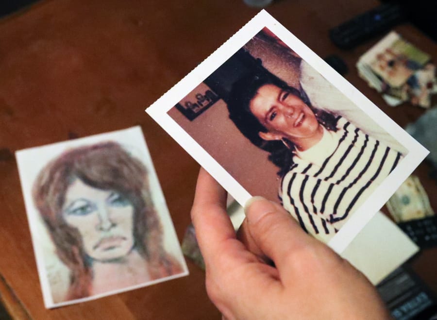 In this Thursday, Oct. 10, 2019 photo, Tonya Maslar holds an old photograph of her mother Roberta Tandarich taken before her death in 1991 in Ravenna, Ohio. Tandarich&#039;s body was found dumped at Firestone Metro Park in 1991. A sketch of Tandarich drawn by serial killer Samuel Little, who claims Tandarich was one of his many victims, lies in the background.
