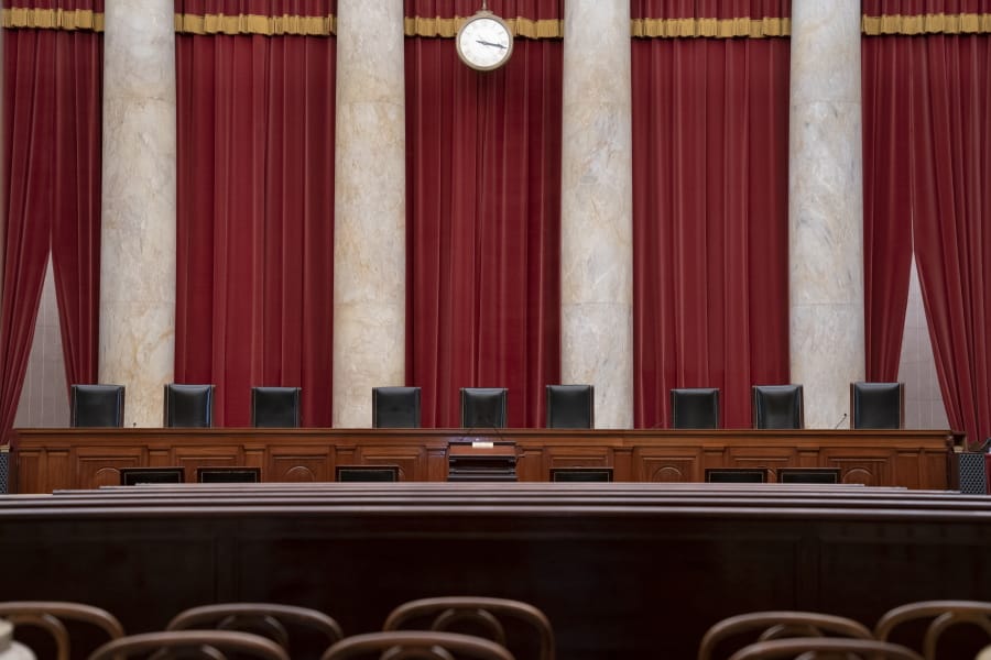 FILE - In this June 24, 2019 file photo, the empty courtroom is seen at the U.S. Supreme Court in Washington. (AP Photo/J.