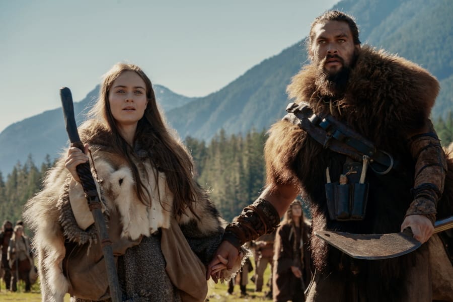 This image released by Apple TV Plus shows Jason Momoa, right, and Hera Hilmar in a scene from &quot;See,&quot; premiering Friday, Nov. 1, 2019, on Apple TV Plus.