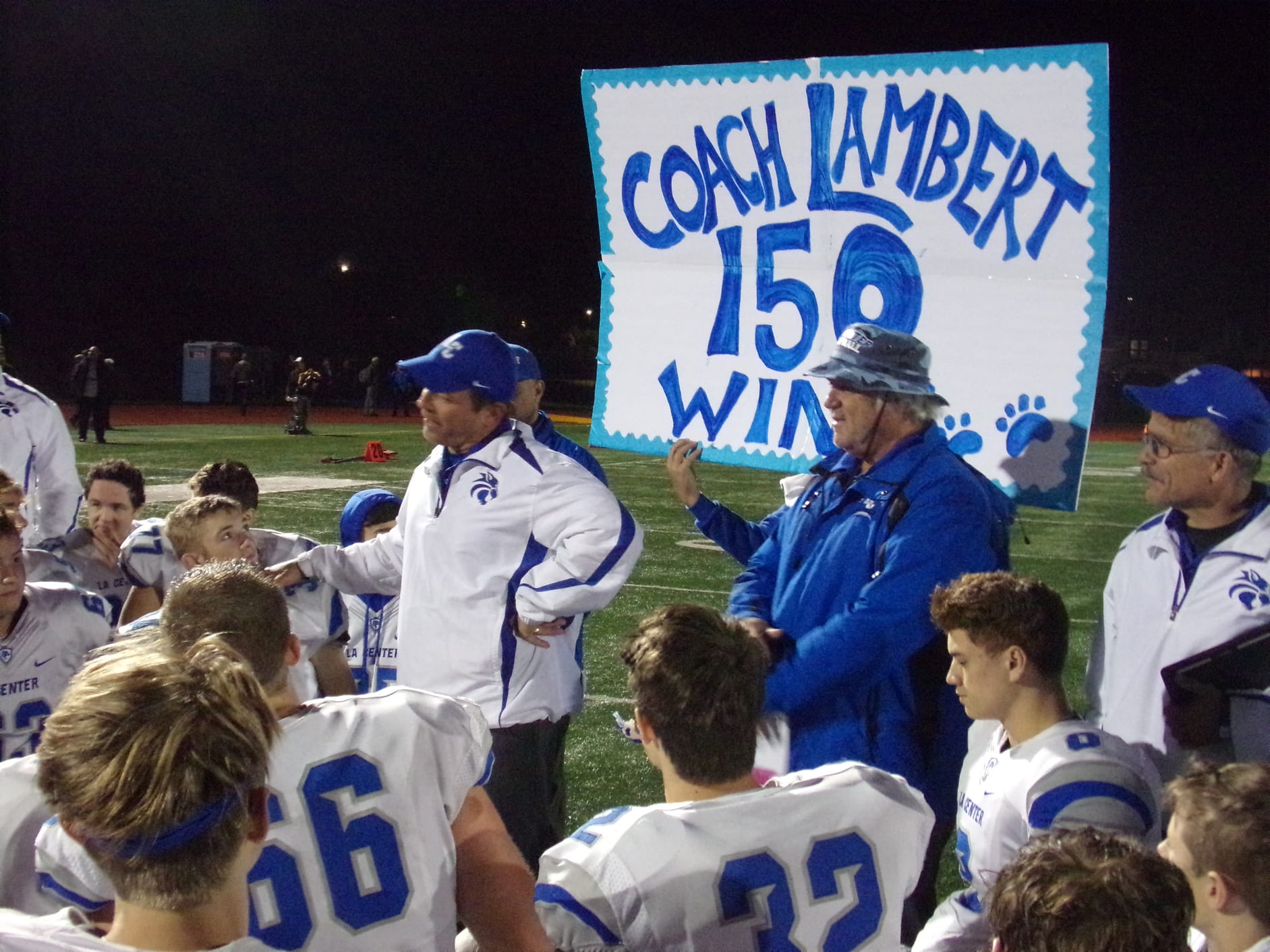 La Center football coach John Lambert talks to his players after beating King's Way Christian on Friday for his 150th career win (Tim Martinez/The Columbian)