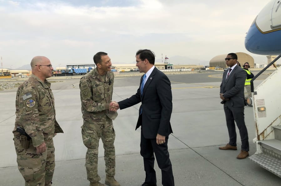 U.S. Defense Secretary Mark Esper, right, is greeted by U.S. military personnel upon arriving Sunday in Kabul, Afghanistan. (Lolita C.
