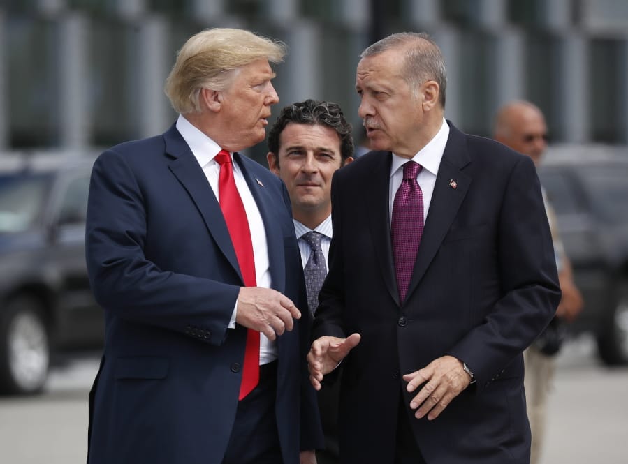 FILE - In this Wednesday, July 11, 2018, file photo, President Donald Trump, left, talks with Turkey&#039;s President Recep Tayyip Erdogan, as they arrive together for a family photo at a summit of heads of state and government at NATO headquarters in Brussels. The White House says Turkey will soon invade Northern Syria, casting uncertainty on the fate of the Kurdish fighters allied with the U.S. against in a campaign against the Islamic State group.