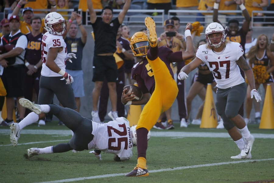 Arizona State quarterback Jayden Daniels, front center, flips into the end zone for a touchdown as he gets past Washington State cornerback Armani Marsh (35), safety Skyler Thomas (25) and linebacker Justus Rogers (37) during the second half of an NCAA college football game Saturday, Oct. 12, 2019, in Tempe, Ariz. (AP Photo/Ross D.
