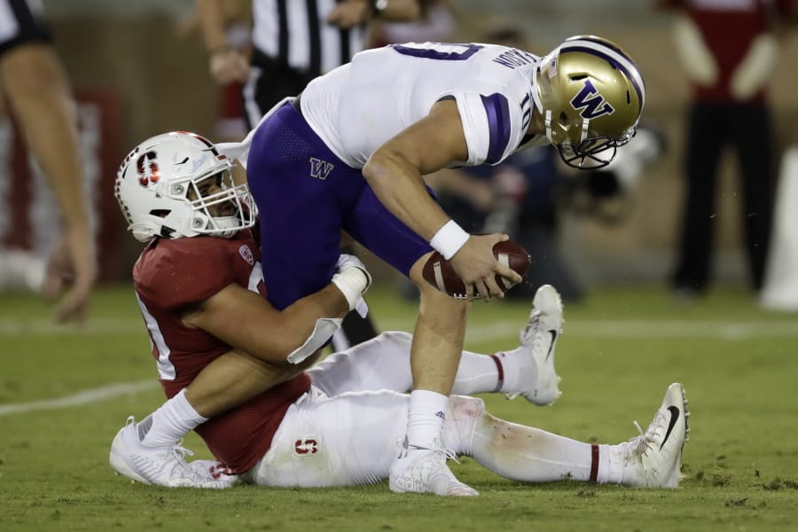 Washington quarterback Jacob Eason is sacked by Stanford&#039;s Scooter Harrington, left, in the second half of an NCAA college football game Saturday, Oct. 5, 2019, in Stanford, Calif.
