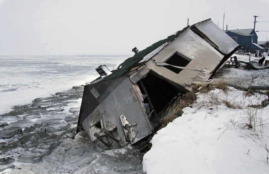 FILE - In this Dec. 8, 2006, file photo, Nathan Weyiouanna&#039;s abandoned house at the west end of Shishmaref, Alaska, sits on the beach after sliding off during a fall storm in 2005. Attorneys for 12 young Alaskans who sued over state climate change policy will argue their case before Alaska Supreme Court justices on Wednesday, Oct. 9, 2019. The lawsuit says state policy that promotes fossil fuels violates the constitutional right of young Alaskans to a safe climate.