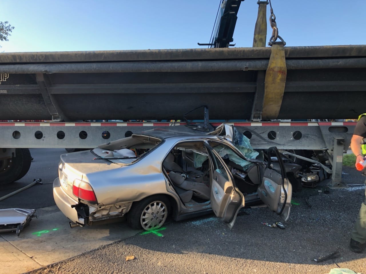A driver is in critical condition after being pinned under a tractor-trailer Wednesday afternoon in east Vancouver.