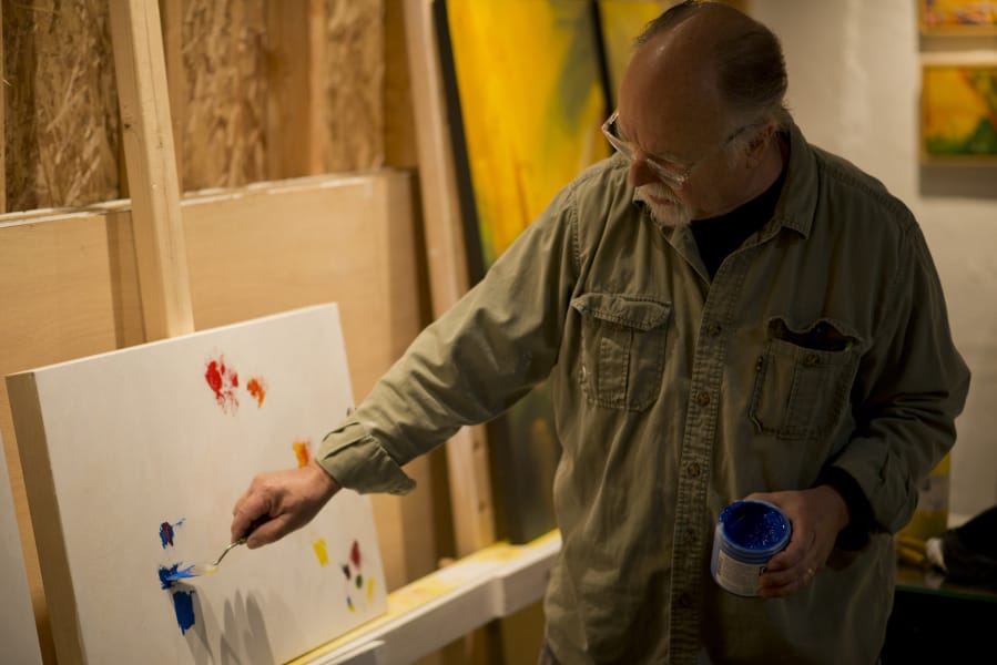 Artist Tom Relth shows visitors his work during the 2018 Clark County Open Studios tour.