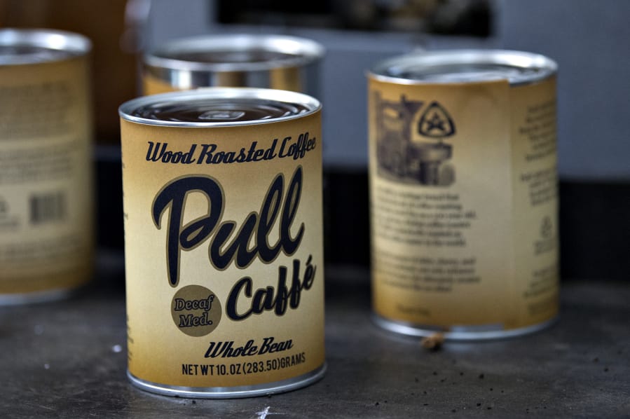 Finished cans of mocha-Java decaf whole bean coffee are seen at Millars Wood Roaster Coffee in Yacolt on Wednesday afternoon, Oct. 23, 2019.