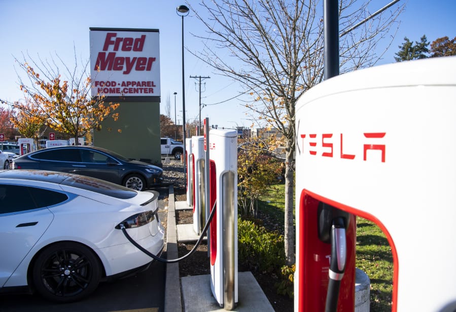 Teslas charge at the Tesla Supercharger station in the Fred Meyer parking lot in Salmon Creek in 2019.