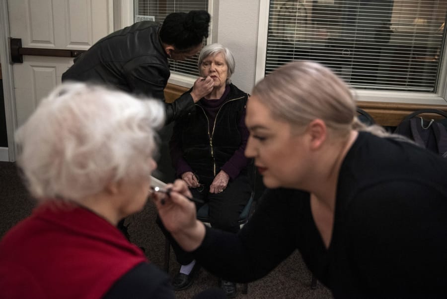 Certified makeup artists Monique Contreras, back left, and Cedar Lapp, right, apply makeup to Lucy Campbell, far left, and Beverly Wagner, center, at Vancouver Orchards Retirement Community in Vancouver. In recognition of Alzheimer&#039;s awareness month, activities coordinator Tracy Shanks organized a makeover with Cedar&#039;s Academy of Makeup Artistry, and a photo session for the residents.