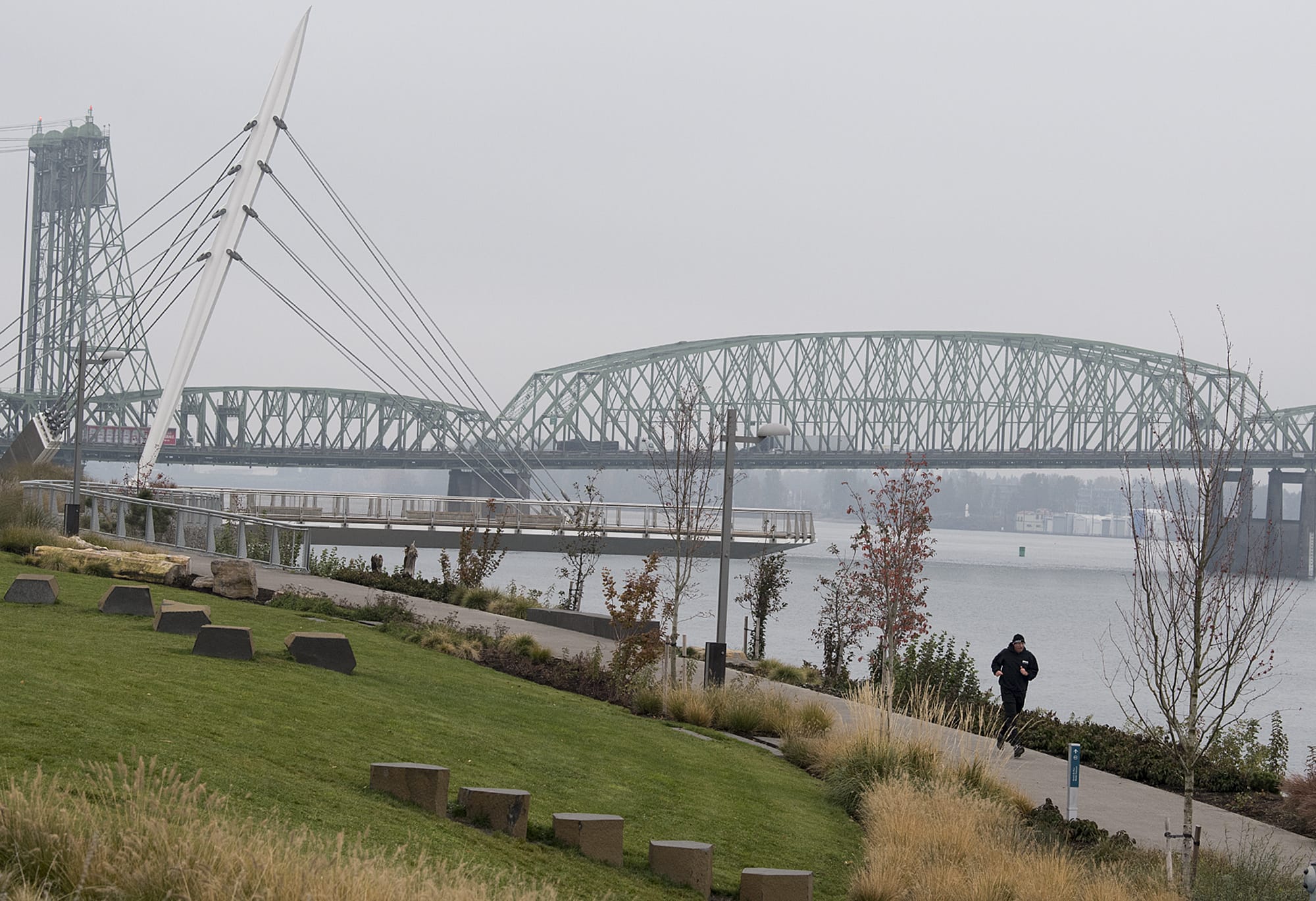 Battle Ground resident James Fields takes the fog in stride while running near the Grant Street Pier as stagnant air causes the fall air to linger Monday morning, Nov. 4, 2019. Fields, who works in Vancouver, said he was been enjoying the sport since junior high and the cool, seasonal temperatures were a bonus for joggers. "This is a beautiful time to run," he said.