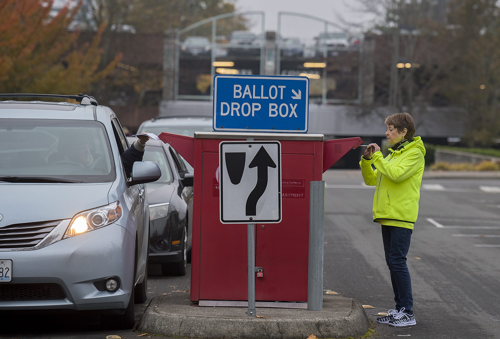 Jan Trygg of Vancouver drops off her ballot on foot at the downtown drop-off box on Tuesday morning.
