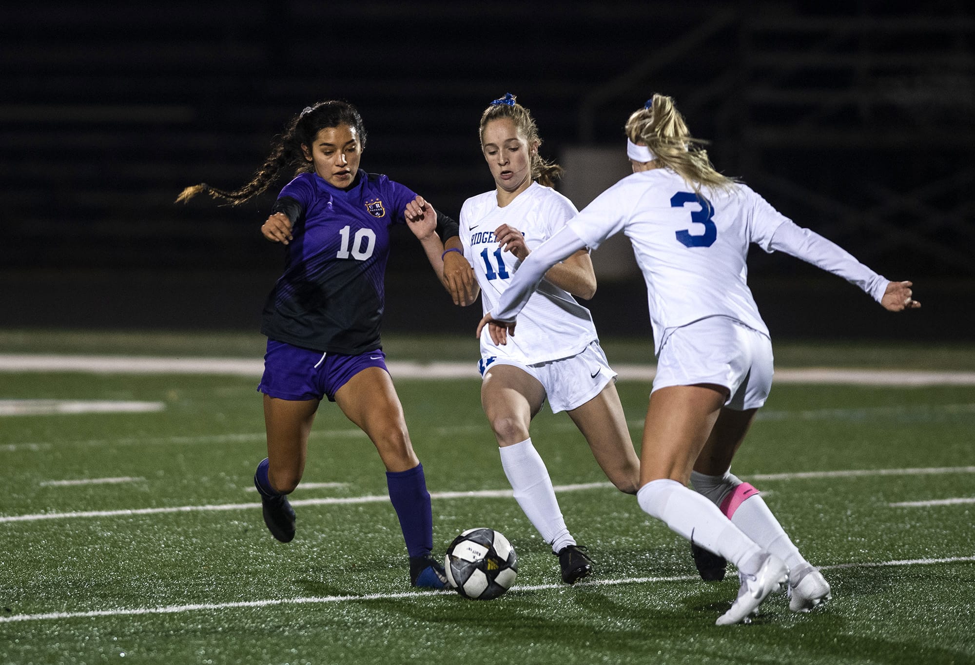 Columbia RiverÕs Yaneisy Rodriguez (10) fights for the ball against RidgefieldÕs Claire Jones (11) during the 2A district championship at Columbia River High School in Vancouver on Nov. 7, 2019. Ridgefield won 2-1.