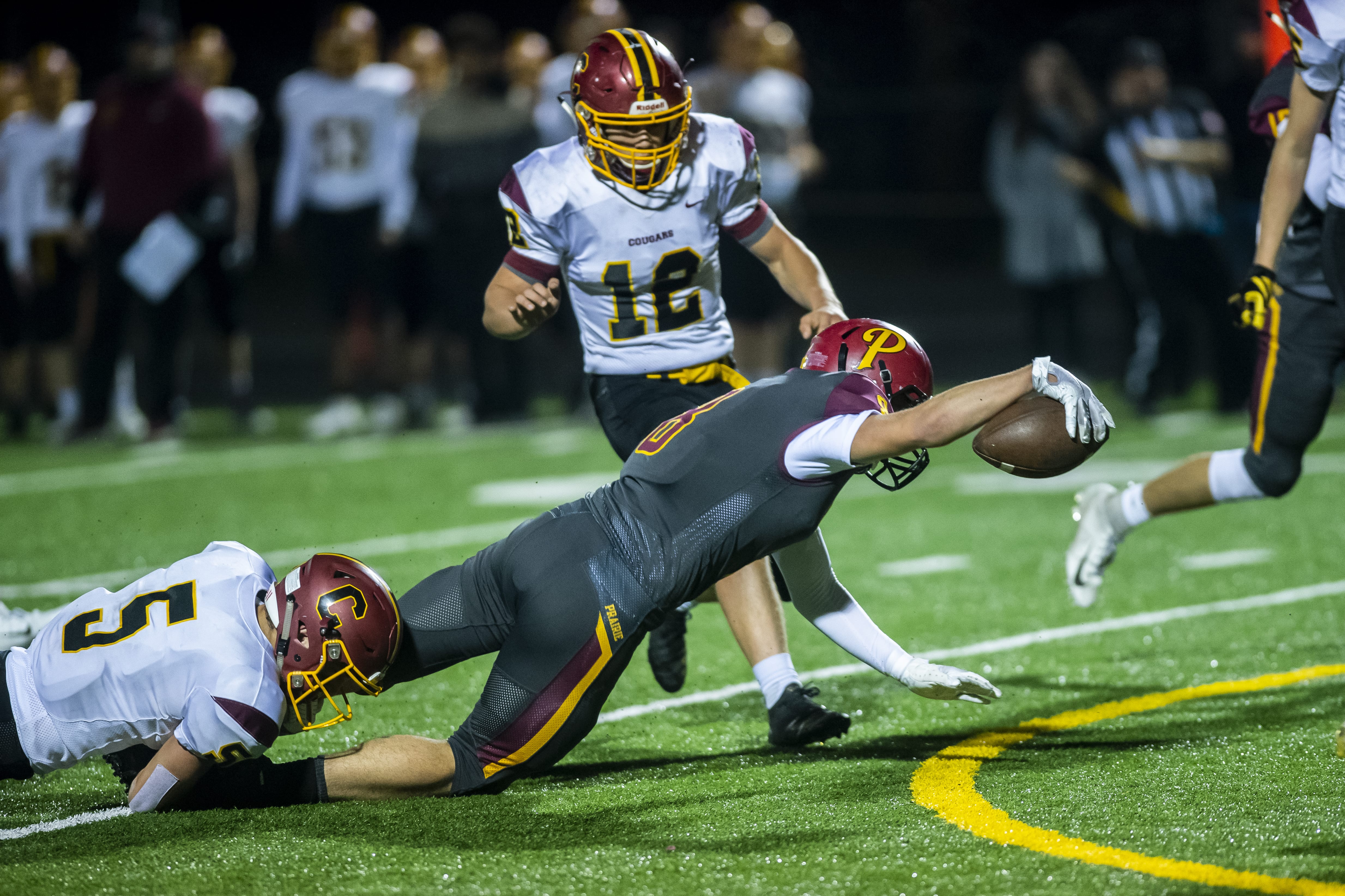 Prairie’s Jamien Farrell reaches for extra yards while being brought down by a Capital defender during a game at Battle Ground District Stadium on Friday night, Nov. 8, 2019.
