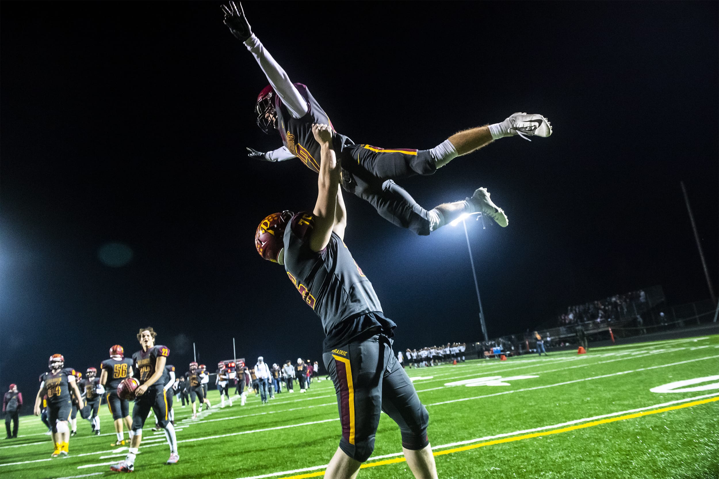 Prairie's Christian Lowry, left, and Zack Brown celebrate the Falcon's 73-35 win over the Capital Cougars at Battle Ground District Stadium on Friday night, Nov. 8, 2019.