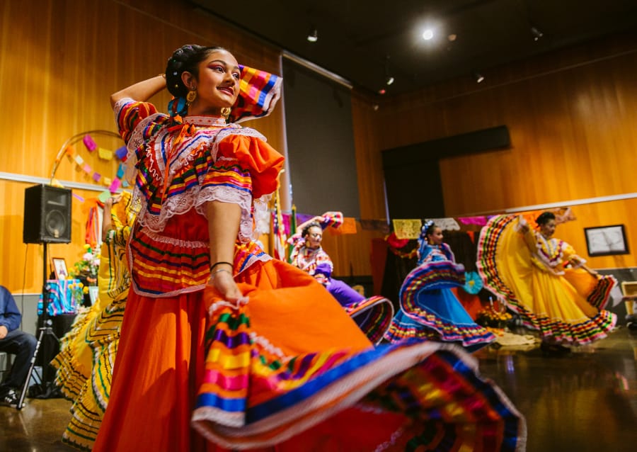 Maia Cruz, 14, of Vancouver, performs a traditional dance from the state of Jalisco, Mexico, with fellow members of Vancouver Ballet Folklorico on Sunday during a Día de los Muertos celebration at the Vancouver Community Library.
