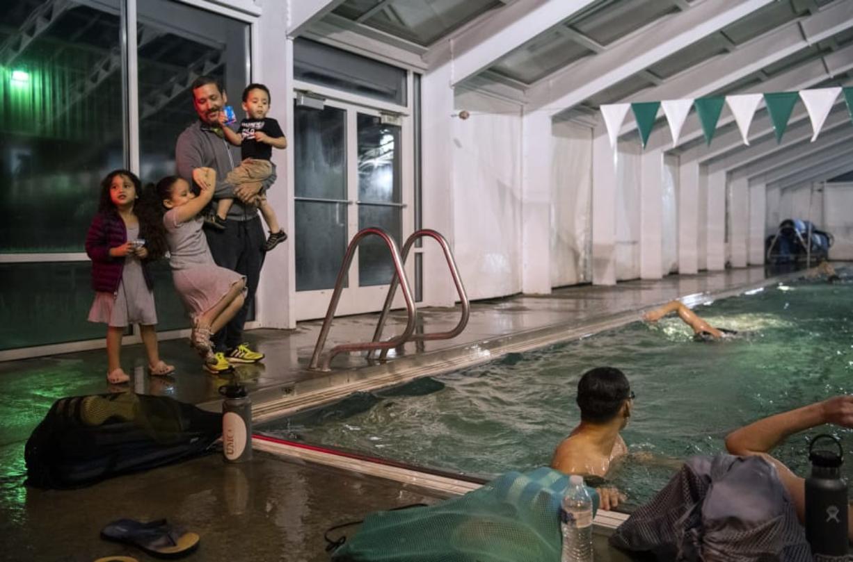 Westley Mejias greets his kids Diana, 4, Sarah, 6, and Manuel, 2, as he coaches at the Lacamas Athletic Club. The kids all take swimming lessons at the club, and Westley?s wife, Juana Santana, is on the masters swimming team. Mejias and his family moved to Camas after Hurricane Maria devastated Puerto Rico, where he coached swimming for a national team and the University of Puerto Rico.