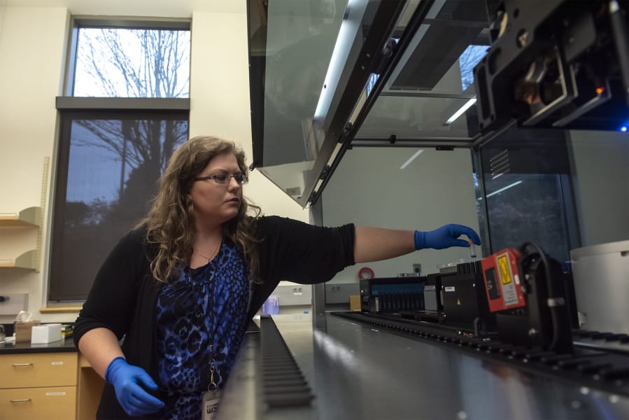 DNA Supervisor Heather Pyles demonstrates the lab&#039;s new $240,000 Hamilton Microlab Autolys STAR liquid-handling robot Friday morning at the Washington State Patrol Crime Lab in Vancouver.