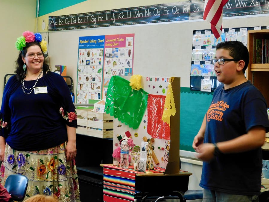 RIDGEFIELD: Rebeca Jaramillo and her son Miguel teach South Ridge Elementary second-graders about Dia de los Muertos.