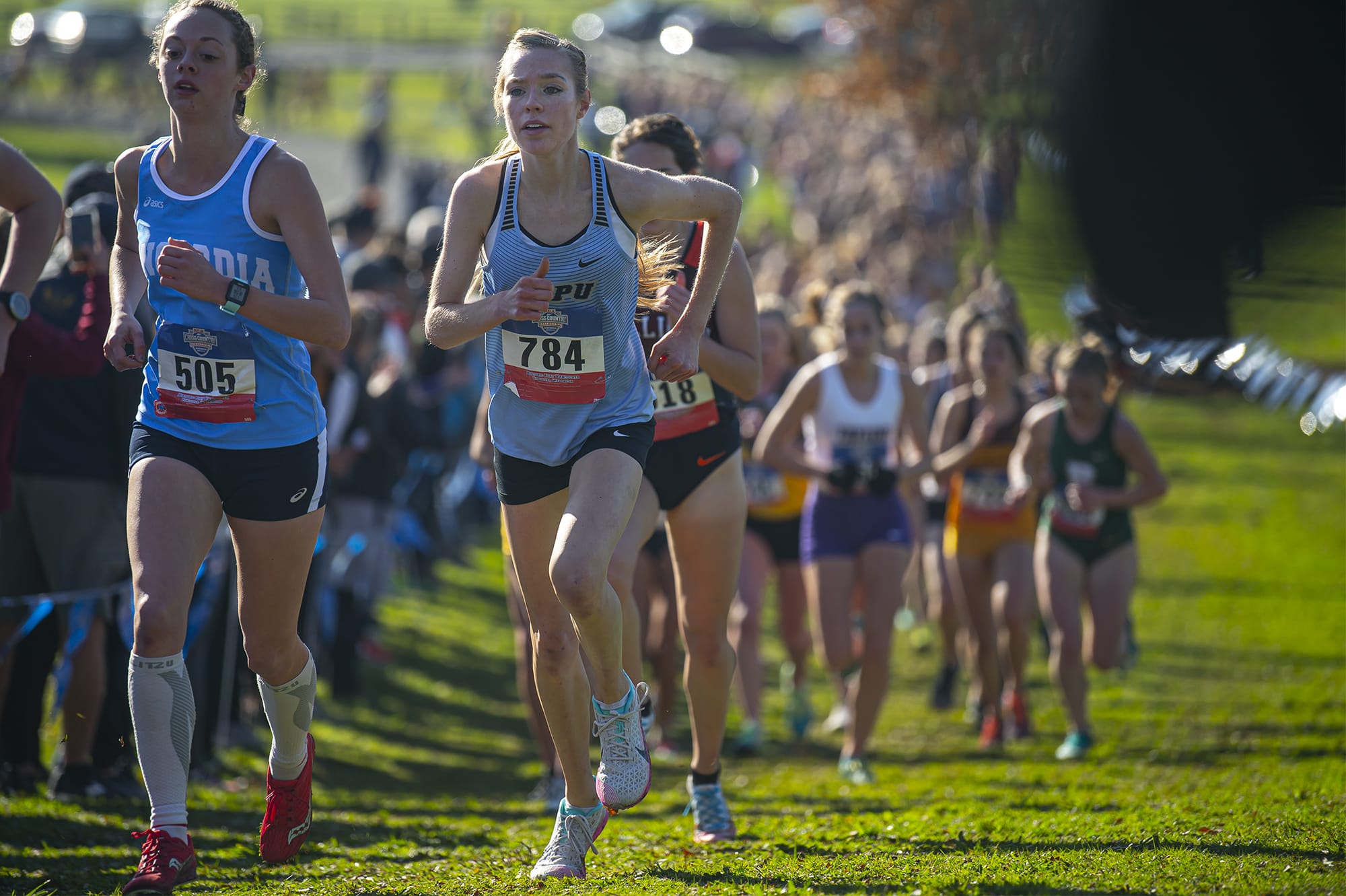 Warner Pacific’s Amelia Pullen, right, competes in the women’s 5 kilometer race during the NAIA Cross Country National Championships on Friday morning, Nov. 22, 2019.
