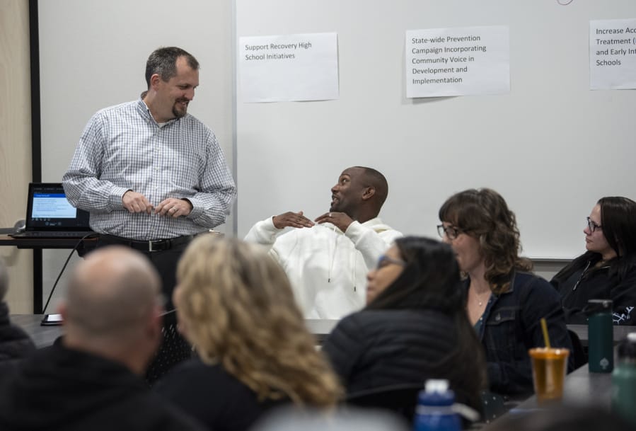 Jim Jensen, a manager of collaboration and learning with Southwest Washington Accountable Community of Health, left, talks with Randall Brewster during an Opioid Task Force meeting at Bridgeview Resource Center in Vancouver. Jensen is the task force facilitator.