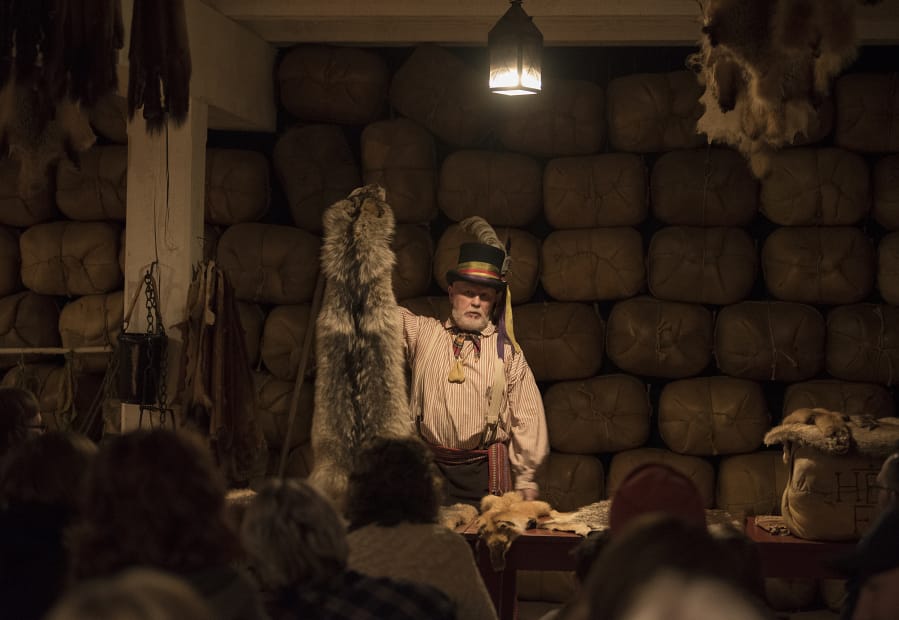 Volunteer Reggie Coats explains what went on in the Fort Vancouver fur store during an October 2017 lantern tour at Fort Vancouver National Historic Site.