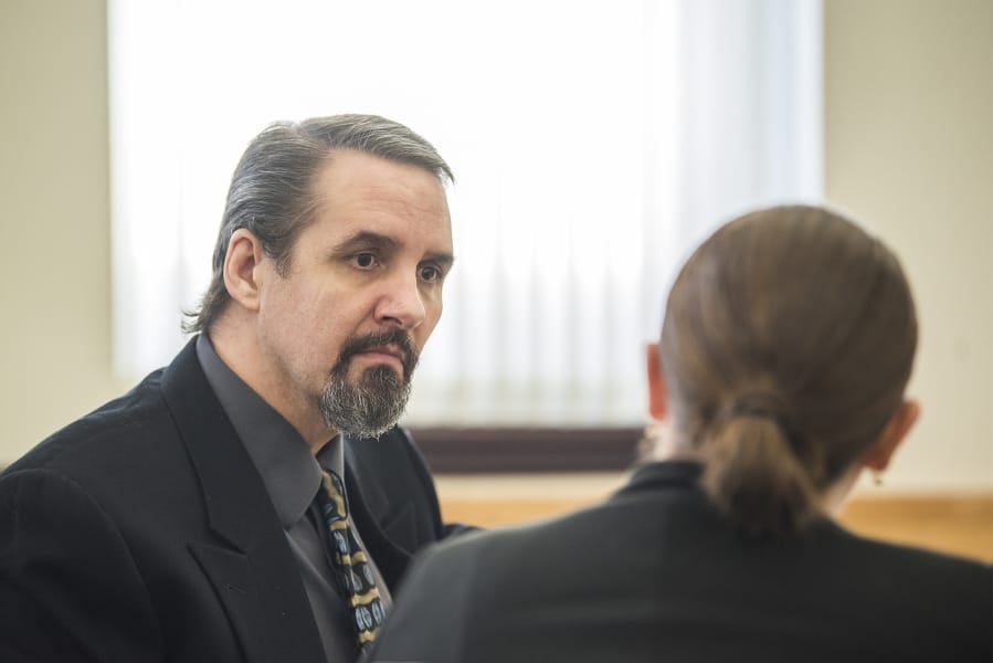 Ronald Jay Bianchi, left, speaks with his attorney Jan. 28 in Clark County Superior Court before the start of a trial on his involvement in a 1997 bank robbery and gun battle in Vancouver.