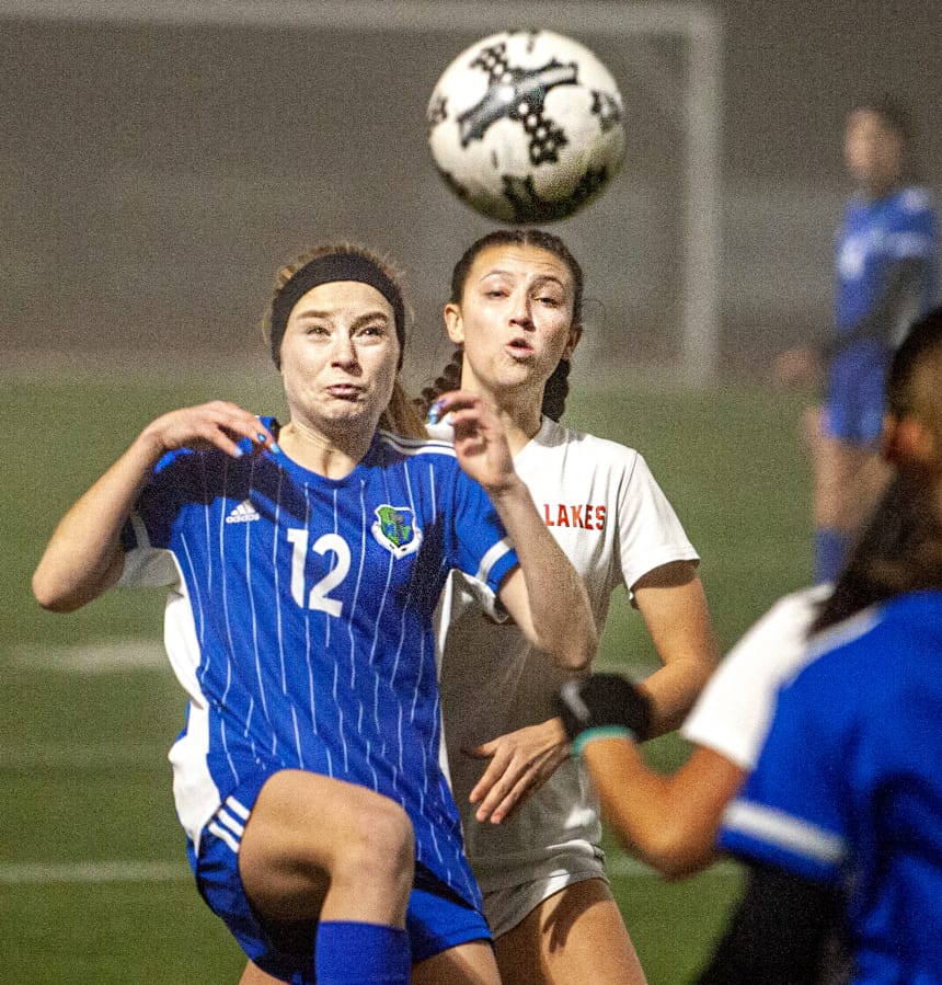 Mountain View&#039;s Ellie White (12) tries to bring down a ball while fending off Lakes&#039; Aly Bryan in a 3A bi-district girls soccer game Tuesday at McKenzie Stadium.