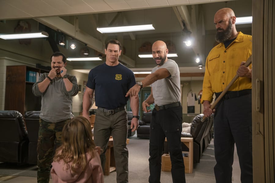 Firefighters John Leguizamo, from left, John Cena, Keegan-Michael Key and Tyler Mane must look after a toddler (Finley Rose Slater) in &quot;Playing With Fire.&quot; (Doane Gregory/Paramount Pictures)