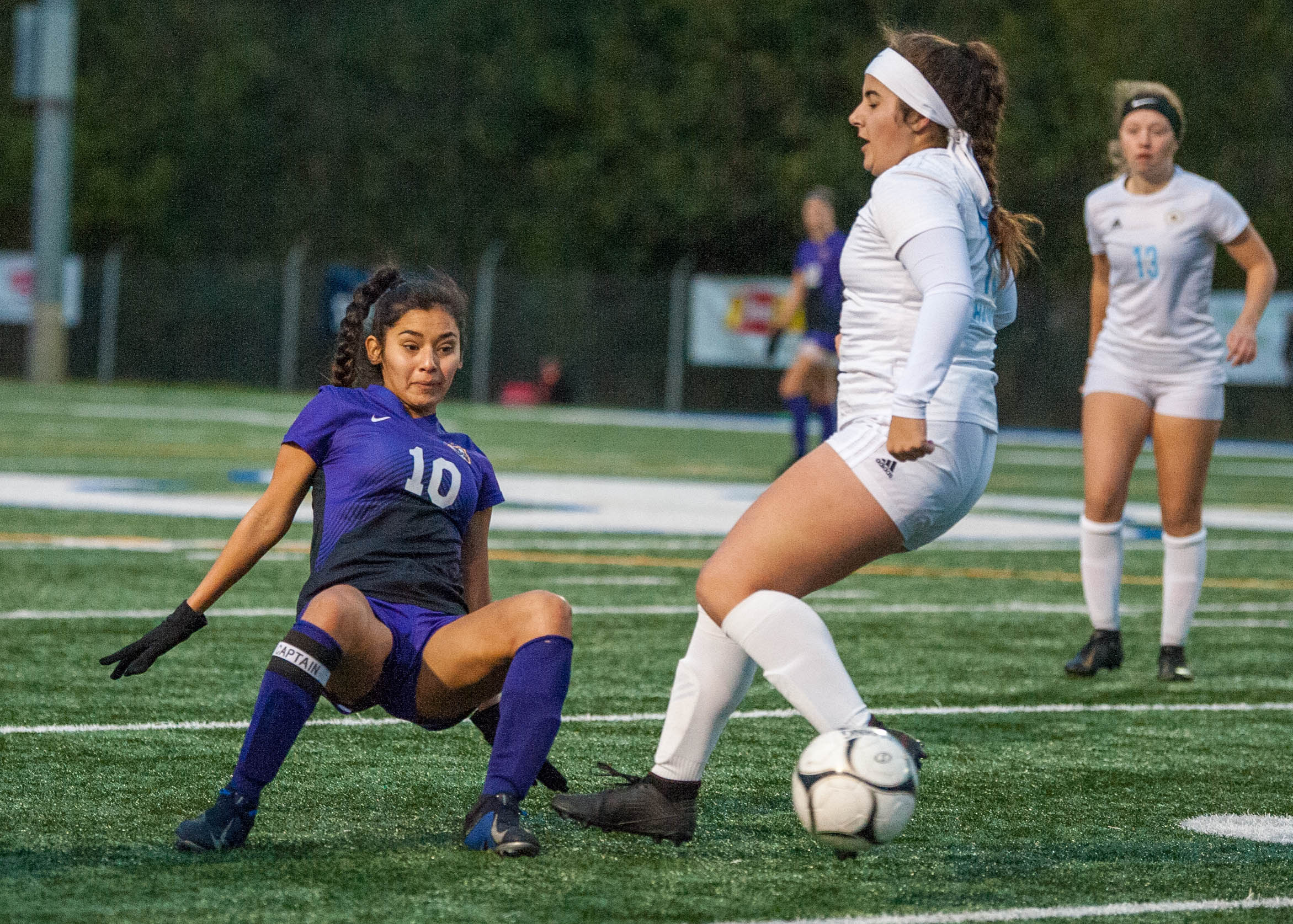Columbia River's Yaneisy Rodriguez slips while making a pass past Hockinson's Ellie Summerson.