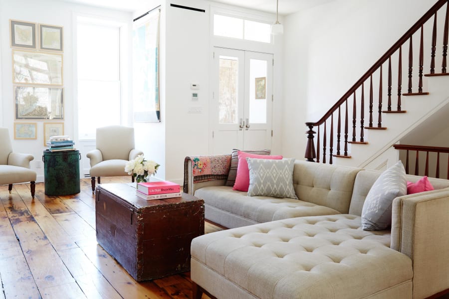 Kim Leggett prefers neutral walls and upholstery to get an authentic farmhouse style. In this renovated Brooklyn brownstone, a simple tufted sectional anchors the space.