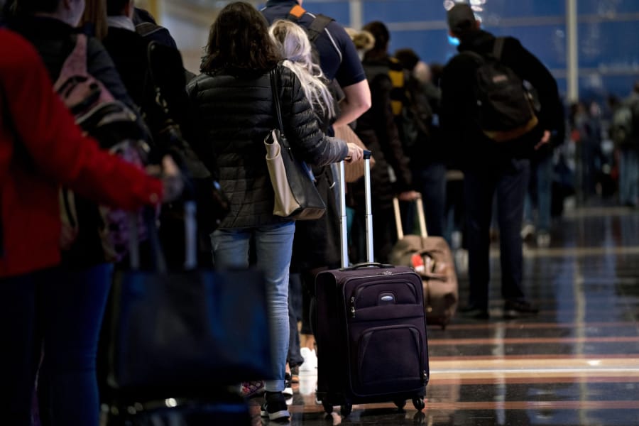 Travelers wait in line Nov. 21, 2018, before going through Transportation Security Administration screening at Ronald Reagan National Airport in Washington.