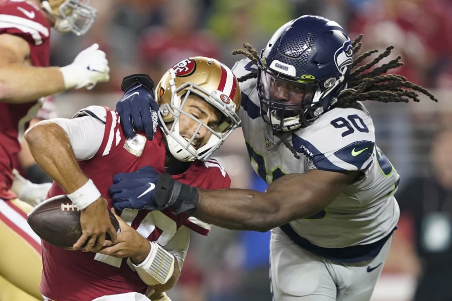 Seattle Seahawks defensive end Jadeveon Clowney (90) tries to take down San Francisco 49ers quarterback Jimmy Garoppolo during the the game on, Monday, Nov. 11, 2019.