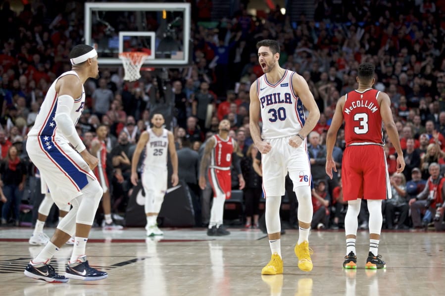 Philadelphia 76ers guard Furkan Korkmaz, right, reacts after making the game winning basket against the Portland Trail Blazers during the second half of an NBA basketball game in Portland, Ore., Saturday, Nov. 2, 2019. The 76ers won 129-128.