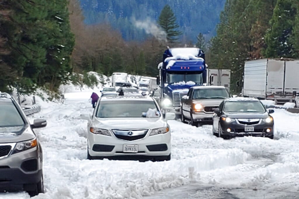 In this photo provided by Caltrans, are cars and trucks in stopped traffic on Interstate 5 near Dunsmuir, Calif., Wednesday, Nov. 27, 2019. Thanksgiving travel has been snarled in some places by two powerful storms. A winter storm blamed for one death and hundreds of canceled flights in the West moved into the Midwest on Wednesday and dropped close to a foot of snow in parts of Minnesota and Wisconsin.